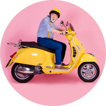 Retired Male on Yellow Scooter Pink Background-1