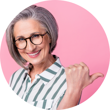 Smiling Retired Female Thumbs Right Pink Background