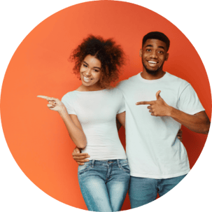 Young Couple Pointing Left Orange Background